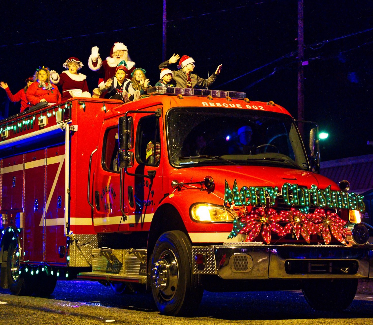 Santa and Mrs. Claus find a fire truck to be the perfect substitute for a sleigh. [more shots here]
